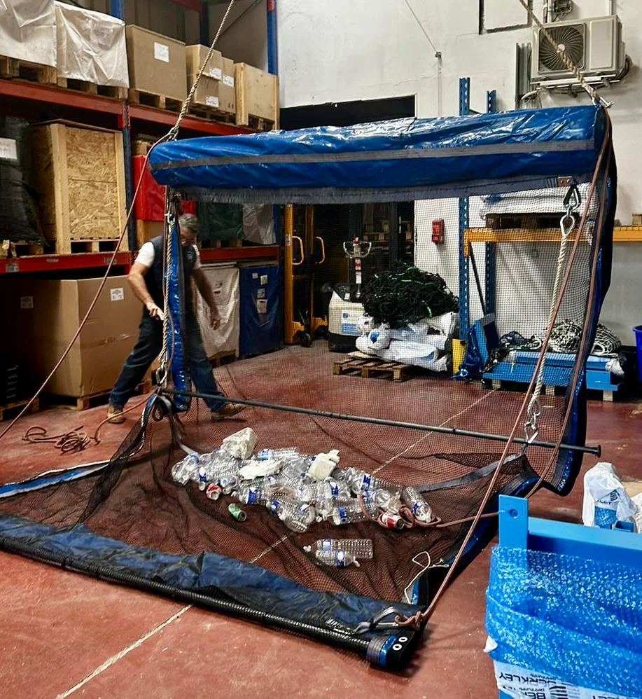 The PolluSub interception net prototype, holding recovered plastic bottles in the workshop