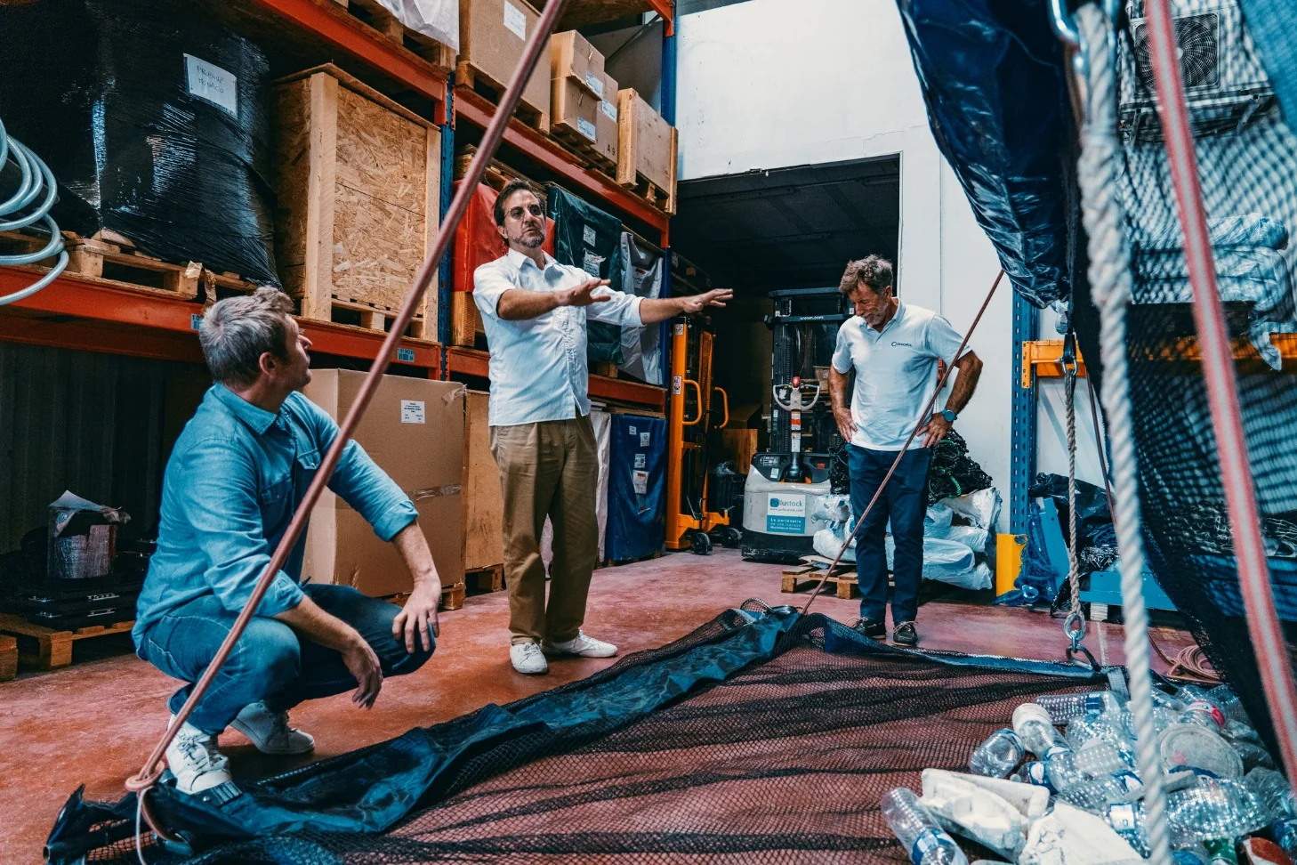 The PolluSub team discussing a prototype net in the workshop